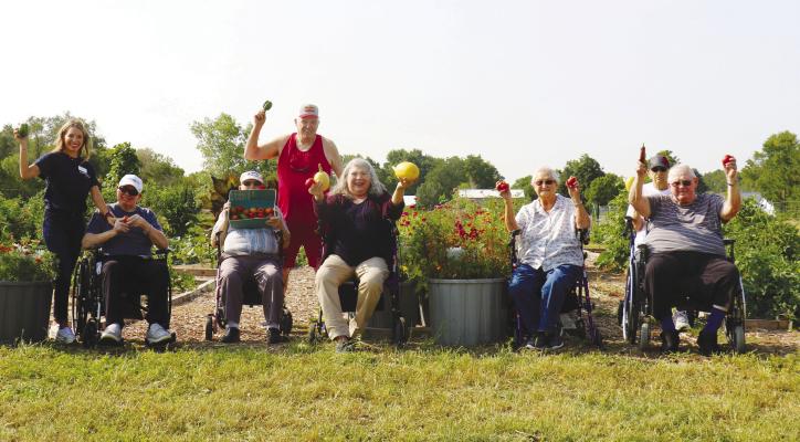 LENDING A HAND at the St. Paul Rotary Club’s Community Garden last week were Melissa Butt, Albert Meyer, Bob Fudge (standing), George Spiknall, Linda Alexander, Willie Powel, Jim Jares (standing), and Dean Dorszynski. The community garden has proven to be a success during its inaugural year, with the staff and residents at Brookefield Park Skilled Nursing and Rehabilitation also taking part in the project. Photo by Michael Rother