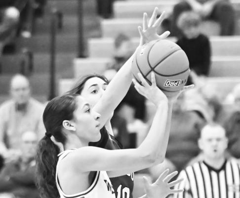 ZAYA LEWIS puts up a shot in the face of a Gibbon defender last week. Lewis had four points in the game on Friday night. Photos by Michael Happ