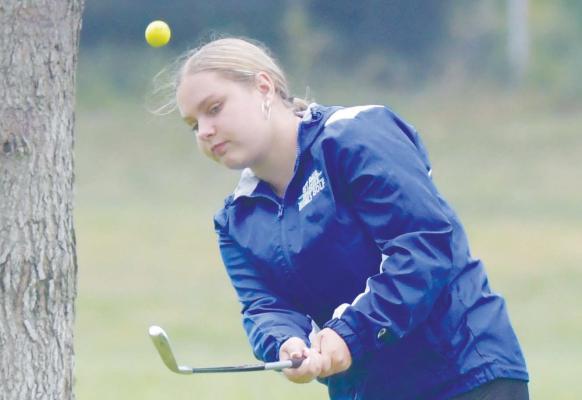 ST. PAUL’S ADDI BROWN chips on to the ninth green during the Wildcats’ home invite last Thursday. Brown hit a 135 for the round. Photo by Michael Happ