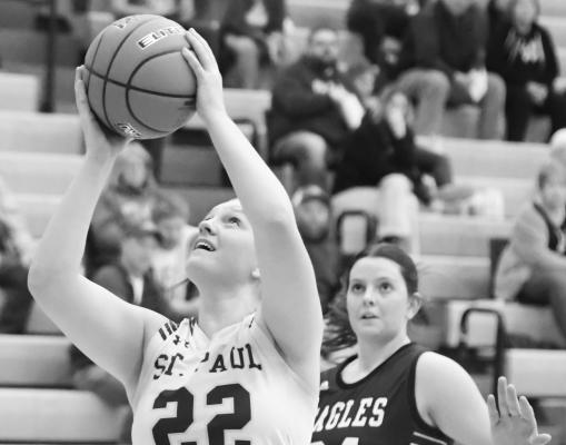 GRACIE KELLEY puts up a shot during the second quarter of last Thursday night’s game against Wood River. Kelley finished the game with twenty-one points and seventeen rebounds. Photos by Michael Happ