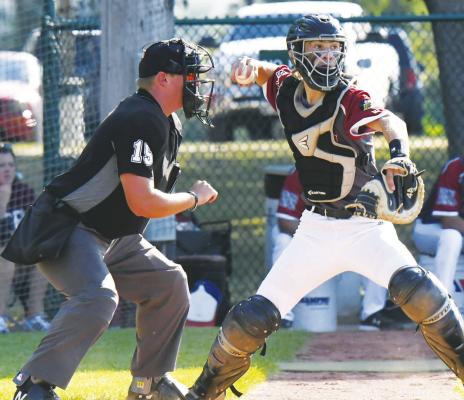 BRYCE GORECKI attempts to pick off a runner at second base during last week’s state tournament championship game played at River Park in Wisner.