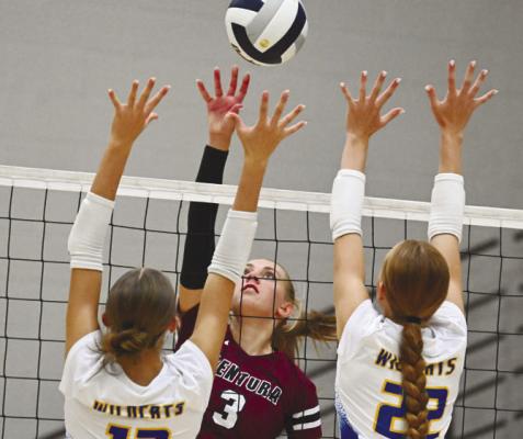 CENTURA’S ELLA FRANCL rises above St. Paul’s Adalynn Wells and Ariel Wells during the second set of last Tuesday’s match between the Centurions and the Wildcats. Photo by Michael Happ
