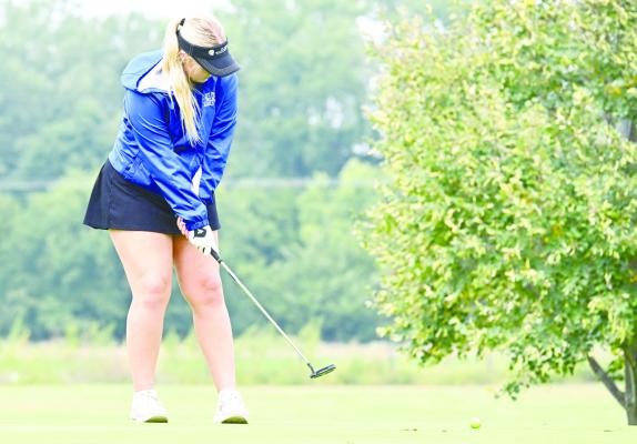 ST. PAUL’S MADISON KLANECKY attempts to sink a putt at the St. Paul Country Club last Friday during the Wildcats’ home quadrangular. St. Paul placed third at their own meet, shooting a 517. Photo by Michael Happ