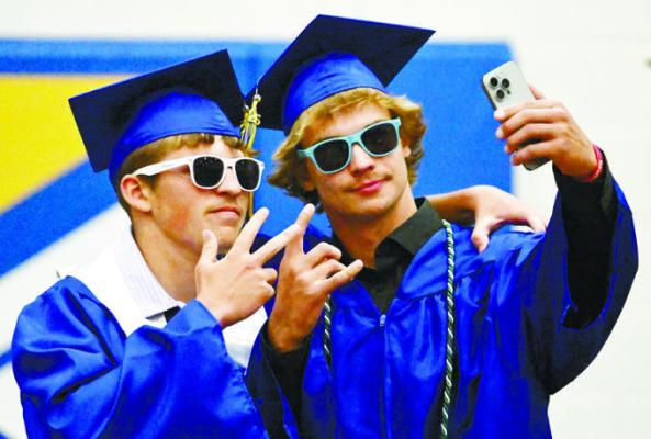 ST. PAUL HIGH SCHOOL GRADUATES Beau Paro and Mason Hoppes pose for a photo prior to Sunday’s recessional during St. Paul High School’s commencement exercises. Photos by Michael Happ