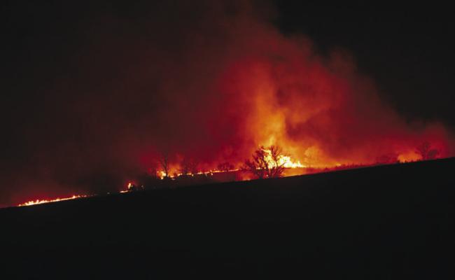 A LARGE FIRE impacted crop and pastureland in rural Howard County on Sunday afternoon and evening. In the wake of the blaze, the county issued a disaster declaration on Monday. Photos by Michael Happ