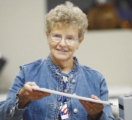 PATTY KRZYCKI helps voters with their ballots at the Posen Precinct in Farwell during last Tuesday’s election. Photo by Michael Happ