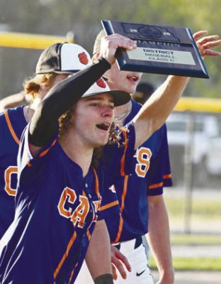 THE ST. PAUL/PALMER CATS had plenty to celebrate after knocking off Malcolm 15-13 in the District C-1 Championship game on Friday night. Above, Zandyn Weller hoists the championship plaque. Photo by Michael Happ