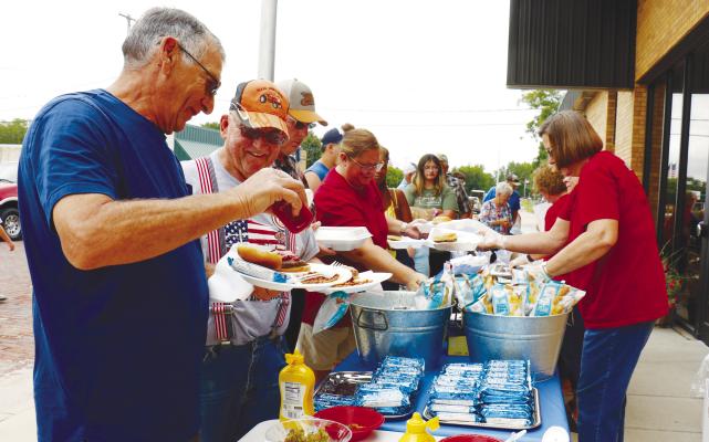 CITIZENS BANK &amp; TRUST CO. in St. Paul held their Community BBQ, with food, prizes, and fun, on Tuesday from 11:00 a.m. until 1:00 p.m. A large crowd turned out for the event, which was held in front of the bank along 7th Street. Pictured preparing their burgers are John Janulewicz and Gene Rice. Photo by Michael Rother