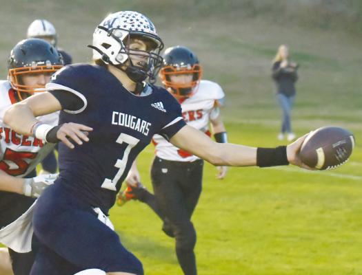 CENTRAL VALLEY’S Zaden Wolf reaches across the goal line for the Cougars’ first touchdown during Friday night’s game against Palmer. Photo by Michael Happ