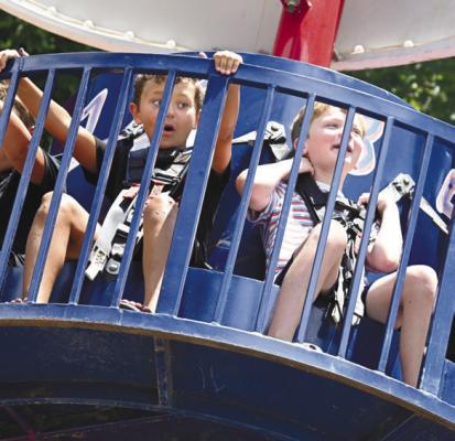 CONNOR HOWARD AND ELLIOTT EGGER were among the many kids that enjoyed the carnival rides on Sixth Street on Saturday morning.