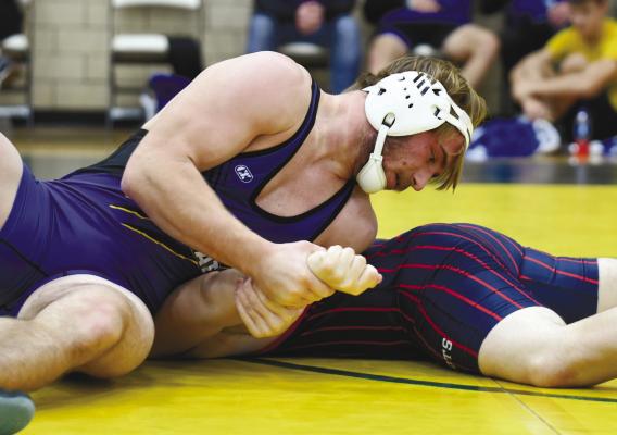 CODY KUSZAK works to pin Simon Smith of Adams Central in the Wildats’ first dual of last week’s tournament at Kearney Catholic. Photo by Jordan Coslor