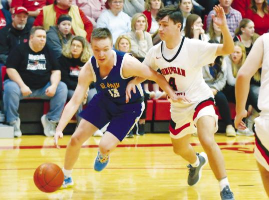 ST. PAUL’S BRAXTON HEATER drives the baseline during the second half of last Tuesday night’s Subdistrict C1-9 semifinal game against Doniphan-Trumbull. Photo by Michael Happ