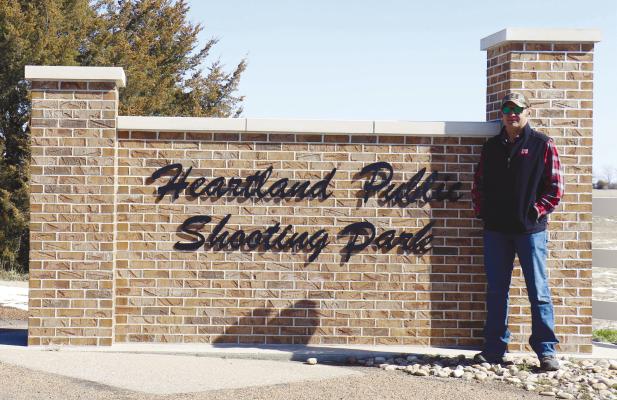 TOM BUSCH is pictured in front of the sign at the Heartland Public Shooting Park near Grand Island last week. Busch recently stepped down as Howard County’s sheriff following fifteen years with the sheriff’s office. Photo by Michael Rother