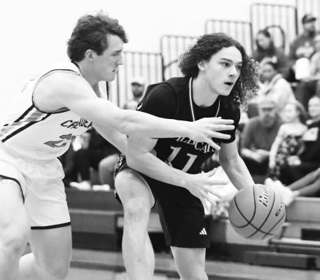 ZANDYN WELLER attempts to edge past a Crusader defender during last Friday night’s regular season finale between St. Paul and Grand Island Central Catholic in Grand Island. Photo by Jordan Coslor