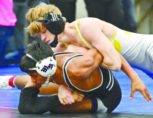 ST. PAUL’S RYLAN RASMUSSEN won a conference title at 120 pounds after he beat Wood River’s Hector Bonilla by a 13-2 major decision on Saturday afternoon. Photos by Michael Happ