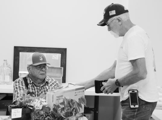 LARRY STEENSON was among the several vendors set up inside the Wolbach Community Center in Wolbach for Junk Jaunt over the weekend. Wolbach, which was home to seven official Junk Jaunt vendors, saw strong turnout from junkers from accross the state, country, and world even before the event officially kicked off last Friday. Photo by Michael Rother