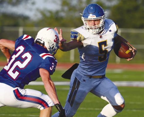 ST. PAUL’S MASON MAJERUS skirts past a Palmyra defender on his way to the end zone for the Wildcats’ first touchdown of the 2026 season. St. Paul beat Palmyra 25-14 for their first win of the year on Friday. Photo by Michael Happ