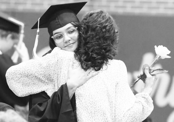 ANNA COOPER embraces a loved one during the Dedication to Parents portion of last week’s graduation ceremony at Elba High School. Photos by Michael Happ