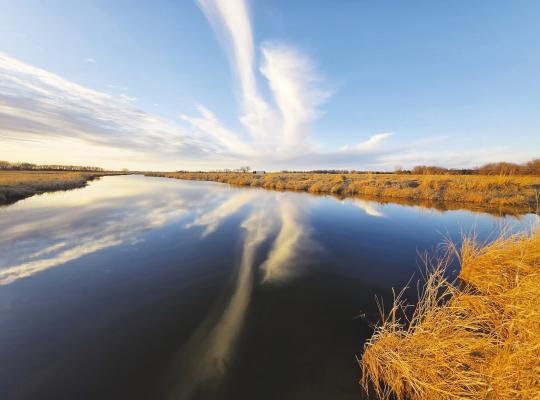 LAWRENCE BURMAN won first place in the Lower Loup Natural Resources District Photo Contest for his image of a deep blue, cloud-streaked sky reflected in a Middle Loup River slough in rural Sherman County. Courtesy Photos