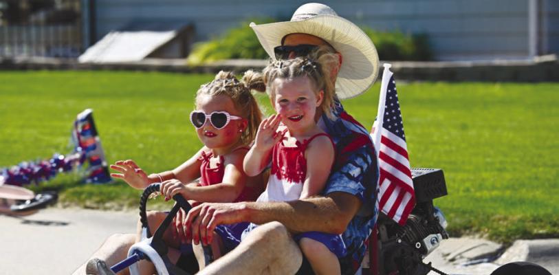 CELEBRATING America’s special birthday in style on Saturday were Navy, Evan, and Raulee Carlson. The trio had one of the many entries in this year’s Bruce Street Block Party Fourth of July Parade in St. Paul. Photo by Michael Happ