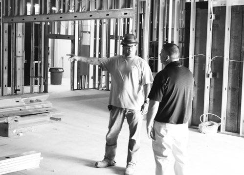HOME PLATE MARKET Owner Blake Schwartz speaks with workers on site at the location of the new grocery store in St. Paul. Photos by Michael Rother
