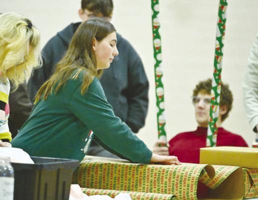 THE ST. PAUL ROTARY INTERACT CLUB held its annual gift wrapping fundraiser at St. Paul Public Schools on December 8th and December 15th. Above, Audrey Anderson works to wrap presents on Sunday afternoon. Photos by Michael Happ