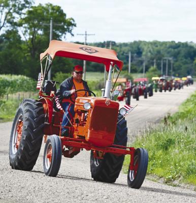 TWENTY-SIX TRACTORS participated in the Central Nebraska Antique Tractor and Equipment Club’s tractor drive north of St. Paul on Friday. Photo by Michael Happ