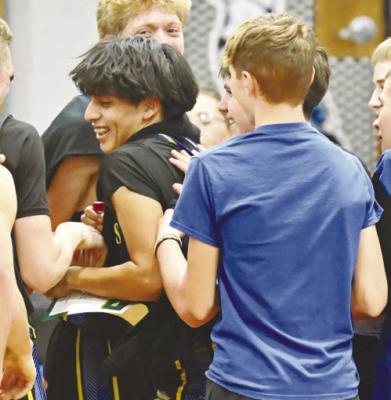 MEMBERS of the St. Paul boys’ basketball team celebrate Bobby Rojo’s record-breaking night. The Wildcat hit eleven of the twelve three-point shots he took against Ravenna, setting a new St. Paul High School record for most three-pointers in a game. Photo by Michael Happ