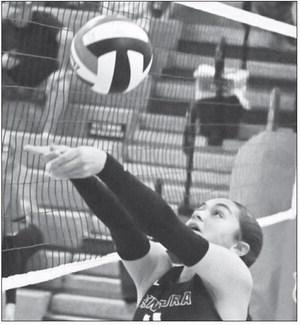 BELLE TAUKIUVEA passes the ball over the net during the final set of last Tuesday’s match against Doniphan-Trumbull. Photo by Michael Happ