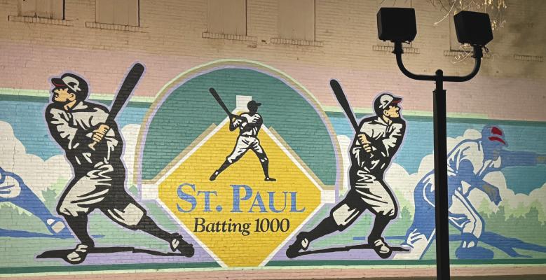 THE “ST. PAUL: BATTING 1000” MURAL in the St. Paul City Park has once again been illuminated following work by crews with the St. Paul Electrical Department. Photo by Michael Happ