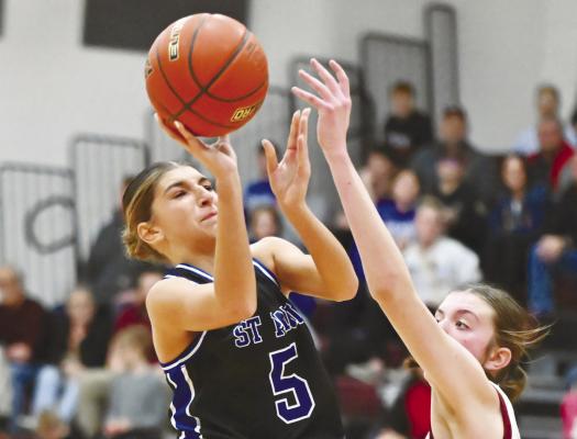 ST. PAUL’S AUBREE FITZGERALD puts up a shot while being defended by Kennedy Davis during last Tuesday’s game at Centura High School. Photo by Michael Happ