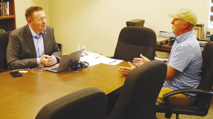JOSH JELDEN, United States Senator Deb Fischer’s central Nebraska constituent services and outreach director, met with se veral people, including Dan Scheer of St. Paul, at a mobile office held in St. Paul last week. Photo by Michael Rother
