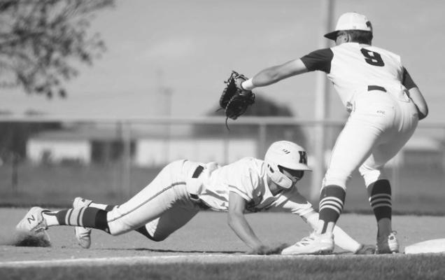 FLETCHER FRIES slides under the tag to thwart Wayne’s attempt to throw the baserunner out on Friday night during the District C-3 championship game at Kernel Field. Photo by Jordan Coslor