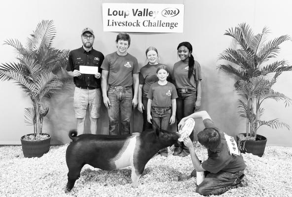 MASON JANDA of Ravenna exhibited the second place breeding gilt at the 2024 Loup Valley Livestock Challenge. He was also named third place swine showman. Janda’s awards, courtesy of BASF and Trotter’s Whoa &amp; Go, were presented by Marty Yantzie of the Loup Valley Ag Society this year. 110 youth exhibitors brought 183 animals to the event in Ord. Courtesy Photo