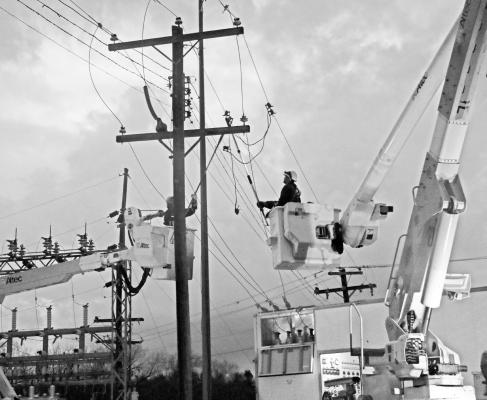 CREWS with Howard Greeley Rural Public Power District work to connect a Nebraska Public Power District generator in Wolbach late Friday night in order to restore power to the Greeley County community following Friday afternoon’s destructive storm. Photo by Michael Rother