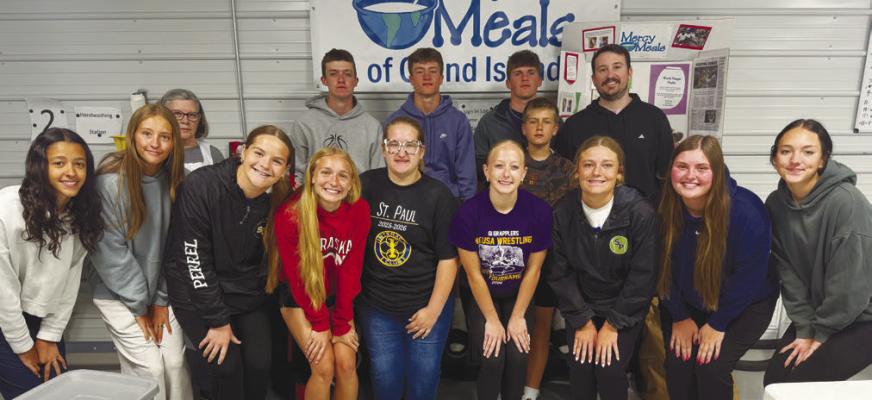 THE ST. PAUL INTERACT CLUB packed 4,104 meals for Mercy Meals at the Orphan Grain Train in Grand Island on Saturday, April 25th. Pictured helping out last Saturday are (back row) Rotarian Loraine Lawler, Maddox Quinn, Max Meyer, Beau Paro, Cade Meyer, and Interact Sponsor Riley Peters; (front row) Zaya Lewis, Addy Wells, Austyn Perrel, Jillian Wells, Karina Smydra, Delaney Jennings, Hadley Quinn, Tessa Dugan, and Macy Porter. Courtesy Photo