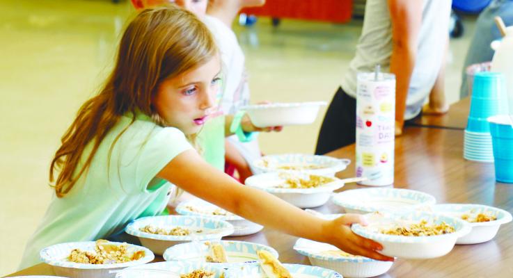 RILEY TIMMONS adds a freshly made protein ball to the collection during St. Paul Summer Rec’s Fun with Food class for kindergarten-through-second-graders last week. The program is one of almost thirty classes offered through the city’s annual summer program this year. Photo by Michael Rother
