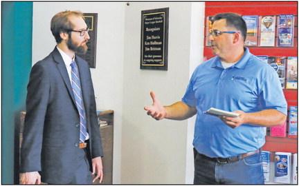 CONGRESSMAN ADRIAN SMITH’S district office held a staff mobile office in St. Paul last Tuesday. During the one-hour event at the St. Paul Chamber of Commerce, Smith’s representative, Michael Bogner, met with area residents to answer questions and hear their concerns. Above, Bogner speaks with Archer Credit Union Associate Vice President of Lending Jason McIntyre during the event. (Courtney Leth)