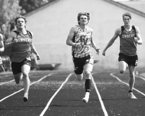 ZADEN WOLF was flanked by Amherst Broncos in the finals of the boys’ 200-meter dash last Wednesday. Wolf placed second in both the sprints, clocking at 11.07 and 22.42, respectively. Photos by Jordan Coslor