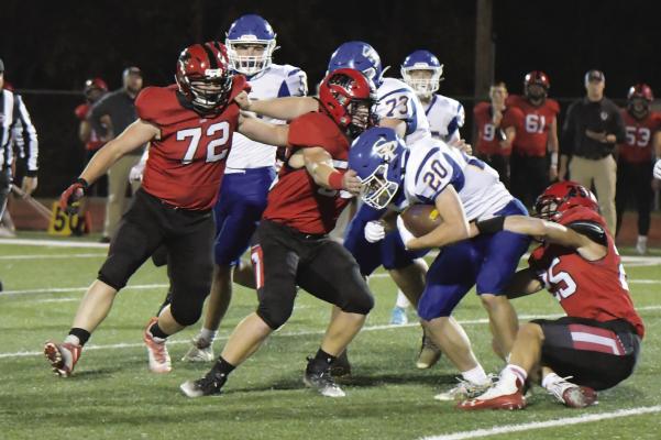 ST. PAUL sophomore Gage Sack attempts to pick up some yards during the second quarter of last Thursday’s game against Boone Central. The Cardinals topped the Wildcats 48-0. (Michael Happ)