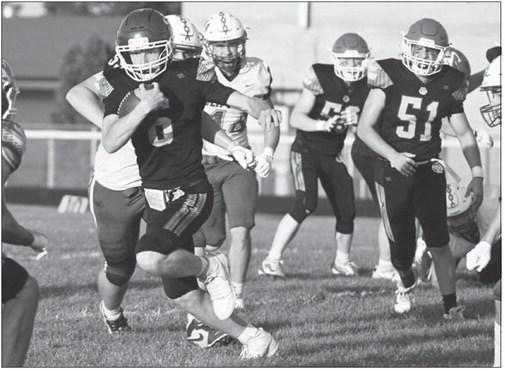 JACKSON WEGNER finds a hole in the Clippers’ defense and cuts upfield during the first quarter of last week’s game against Malcolm. Photos by Michael Happ