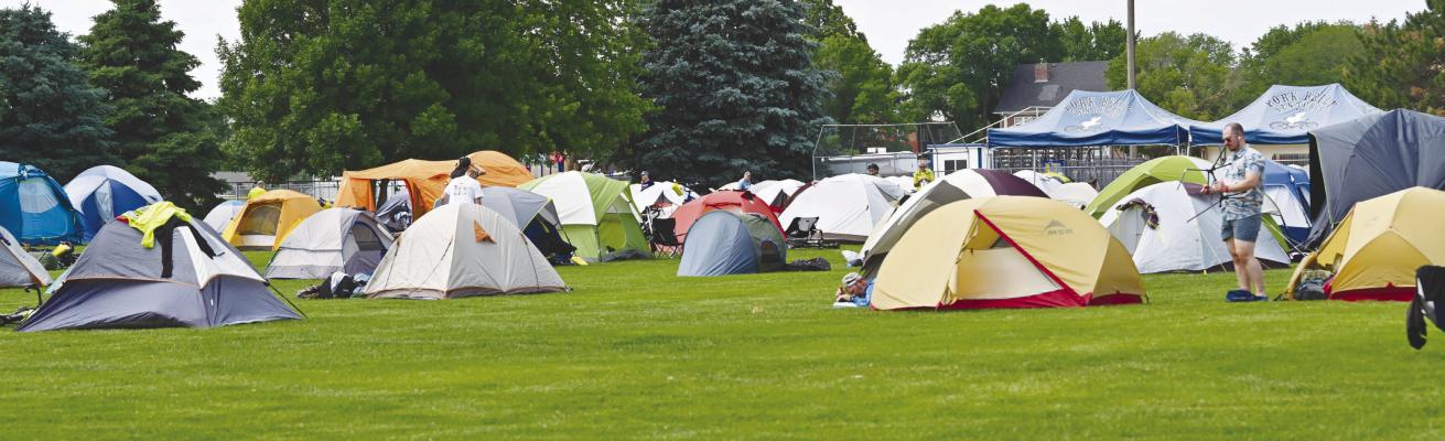 A TENT CITY sprang up south of St. Paul High School on Wednesday night to accommodate the riders with the Bicycle Ride Across Nebraska. The encampment featured various amenities, including shower facilities and overnight quarters for the ride’s officials and volunteers. Photo by Michael Happ