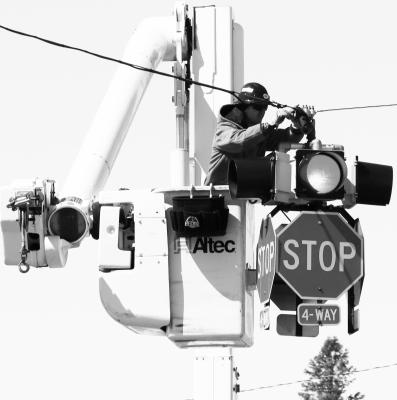 JAROD GREENOUGH with the City of St. Paul Electrical Department got a birds-eye view of Howard Avenue last Wednesday after the flasher went out on the stop light at the corner of Howard Avenue and Seventh Street. The light was quickly repaired and put back into service. Photo by Michael Rother
