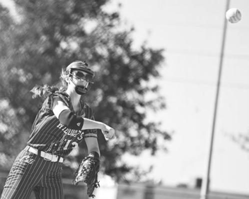 ANNIE STEPANEK makes a throw to first base for an out during Friday’s game against Central City. The Bison defeated the Wildcats 9-1 in the tournament’s consolation finals. Photos by Michael Happ