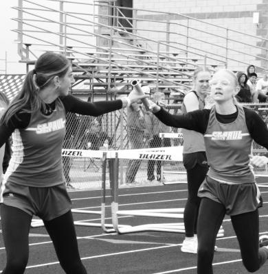 JOHANNAH NIELSEN makes the second exchange of the girls’ 4x800-meter relay with Aubree Fitzgerald at last week’s Ron Priebe Invitational in Gibbon. The Wildcats won the relay in 11:38.93. Photos by Monte Steele