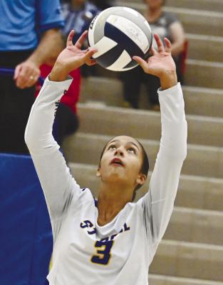 ST. PAUL’S Zaya Lewis sets the ball during the Wildcats’ match against Arcadia/Loup City last Tuesday night in St. Paul. Photo by Michael Happ