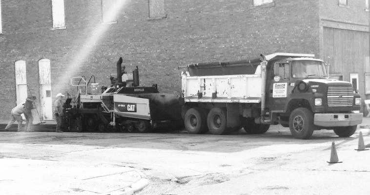 CREWS with JIL Asphalt of Grand Island were busy working on Kingwood Street in Wolbach on Friday evening. Heavy rain in the area had delayed the completion of repair work on the Wolbach street. Photo by Michael Rother