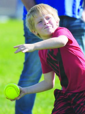 COLT CHRISTENSON launches a softball during St. Paul Elementary’s Field Day on Monday morning.