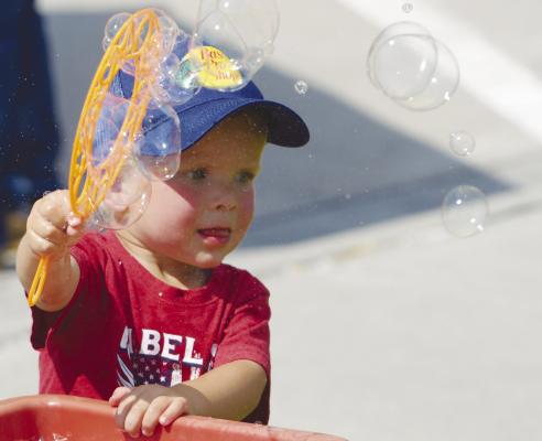 KOVE KUTA makes bubbles at the bubble station during Saturday morning’s fun in the park. The kids’ games were once again a hit during St. Paul’s annual GCA Days celebration. Photos by Michael Happ
