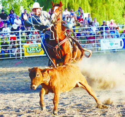 HUDSON EBMEIER of Whitney makes use of his lasso as one of many tie-down ropers to compete in the Wolbach Days Rodeo held on Friday, Saturday, and Sunday.